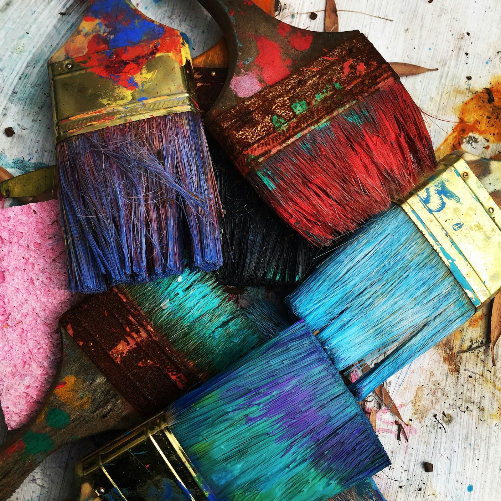 Brushes and mixed acrylic in the anonymous artists studio in natural morning light